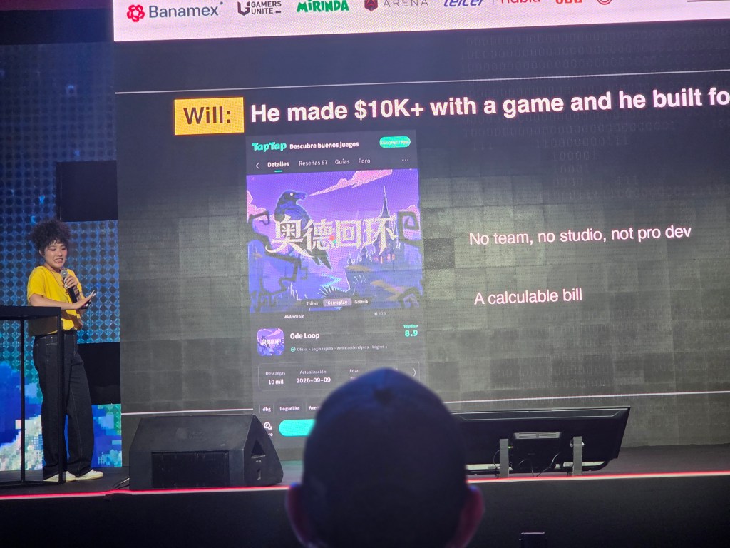 A presenter in a yellow shirt discusses game development on stage, with a slide showcasing the success of a game that earned over $10K. The slide highlights features of the game, mentioning it was created without a team or professional developer.